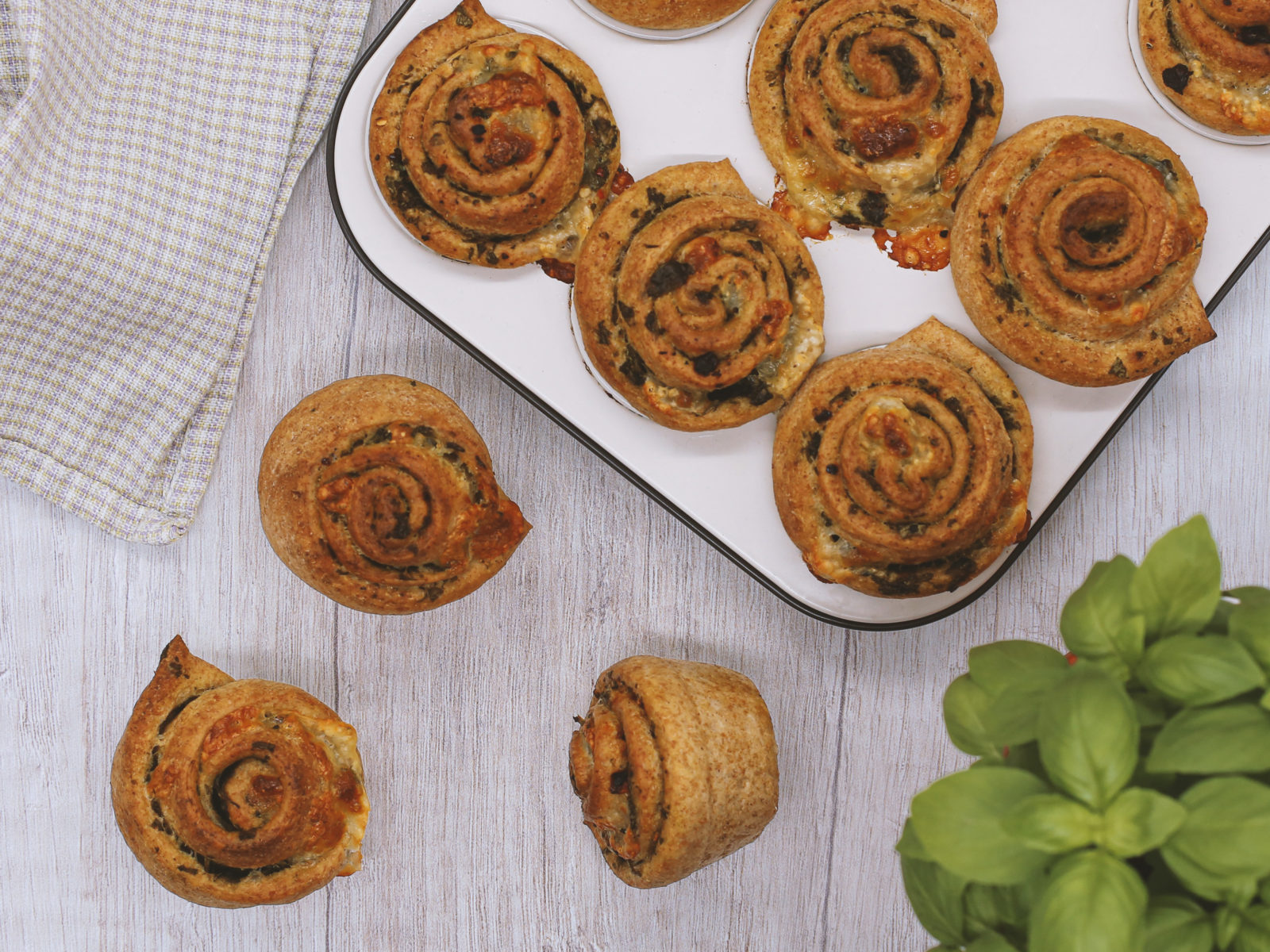 Mozzarella-basil muffins on white background