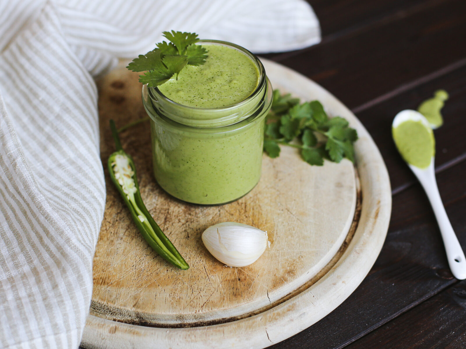 thick green sauce in a glass jar
