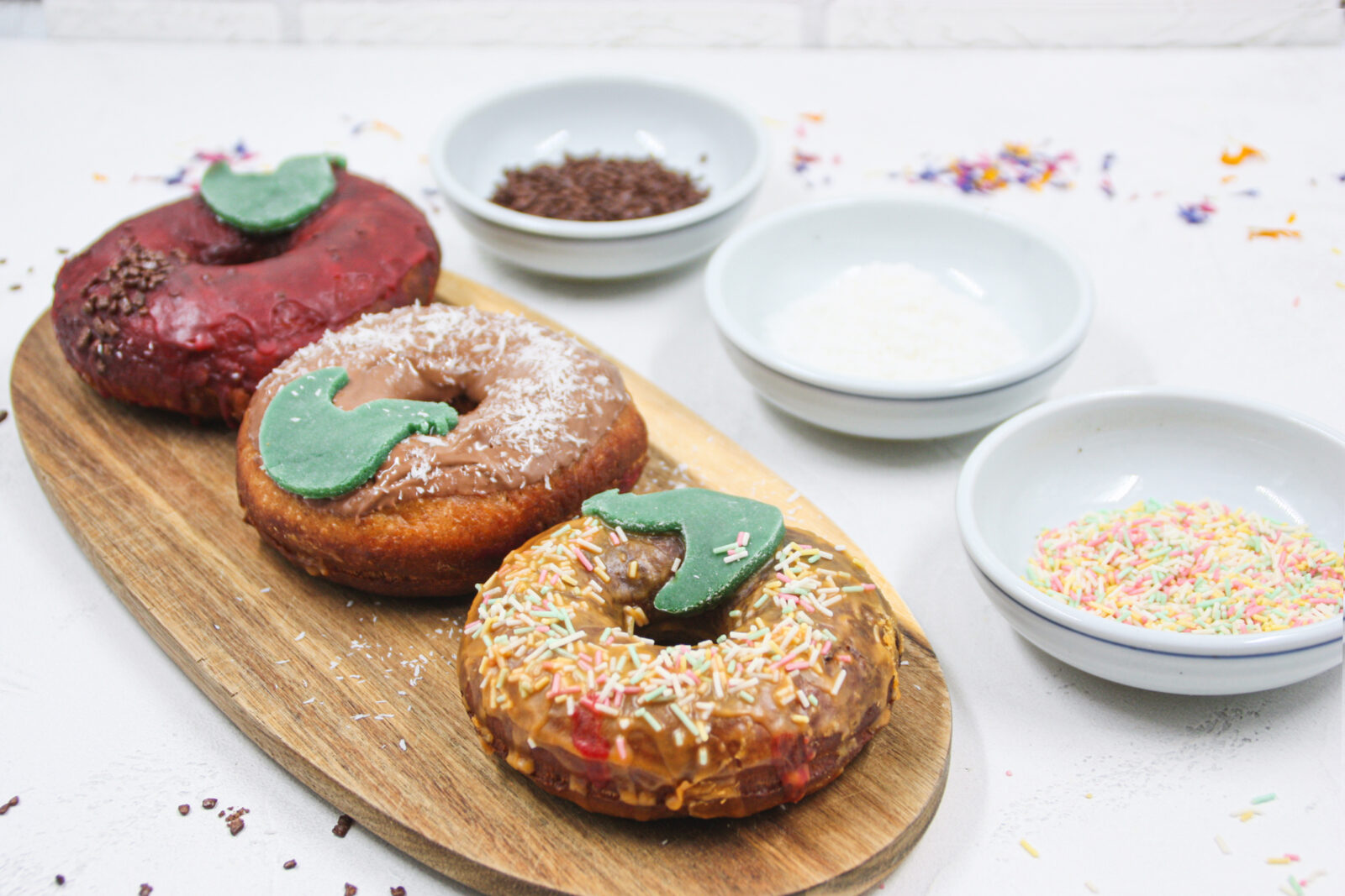 donuts with colourful sprinkles and a green chicken