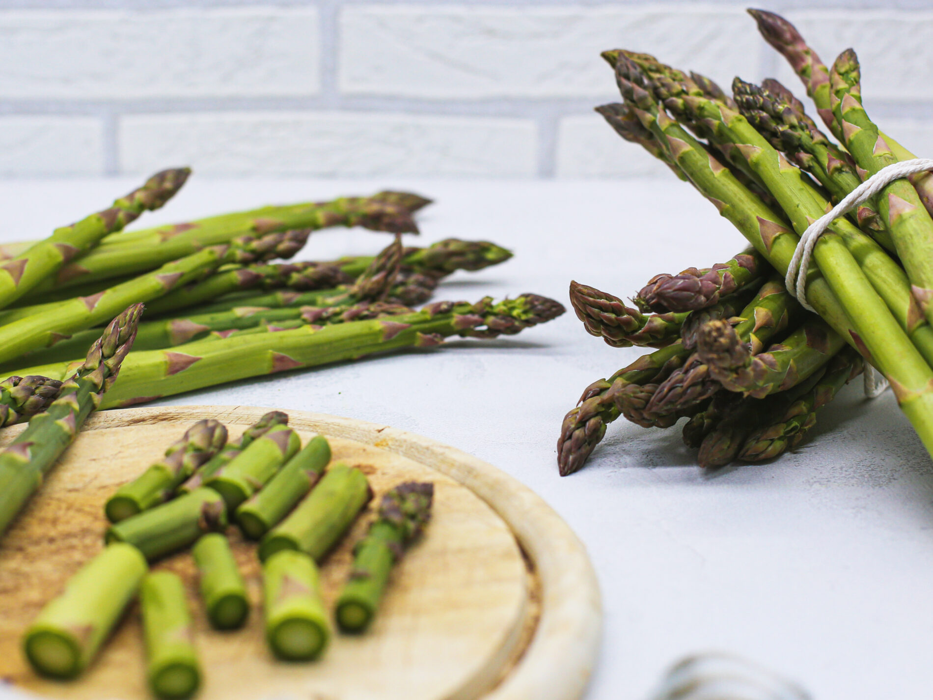Green asparagus in bunches and cut on a cutting board