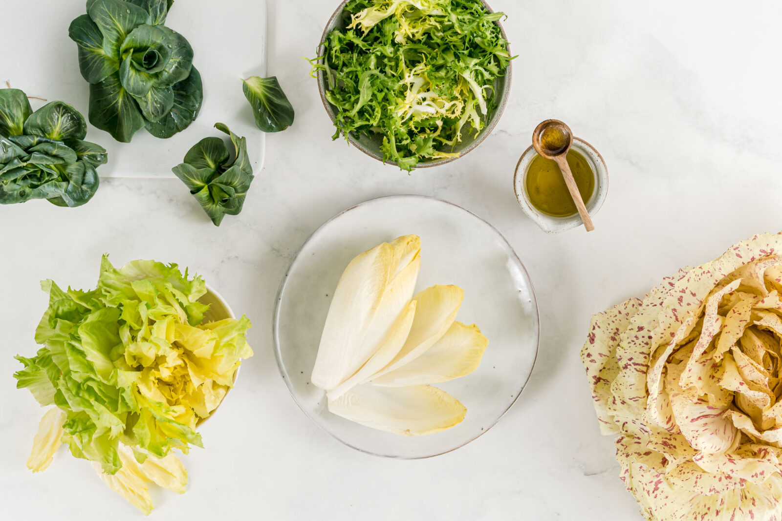 an assortment of lettuce on white background