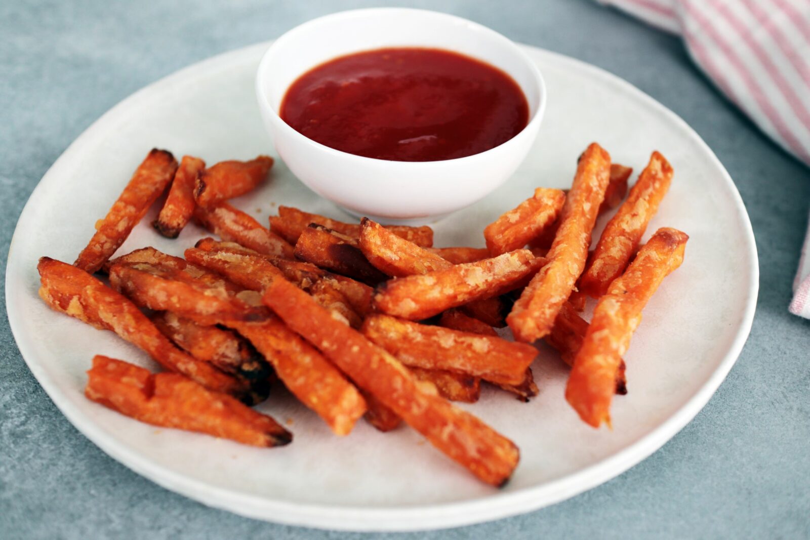 Home made ketchup with sweet potato fries on a plate