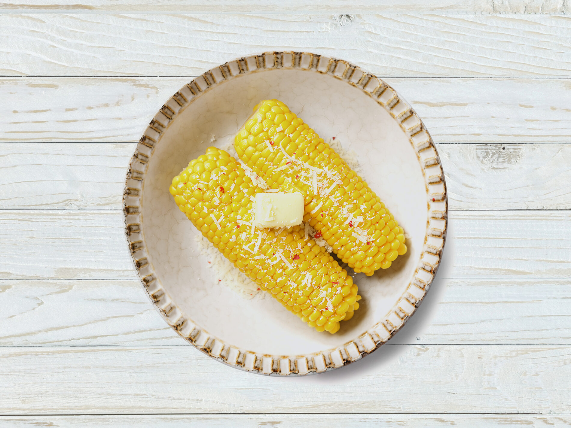 Two corn on the cob with butter