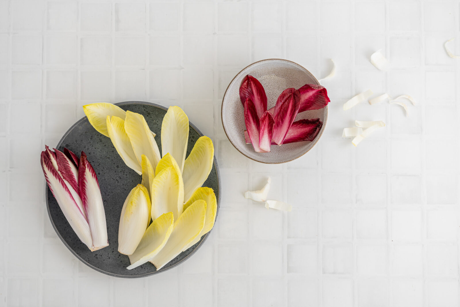 White and red chicory on plates, white background