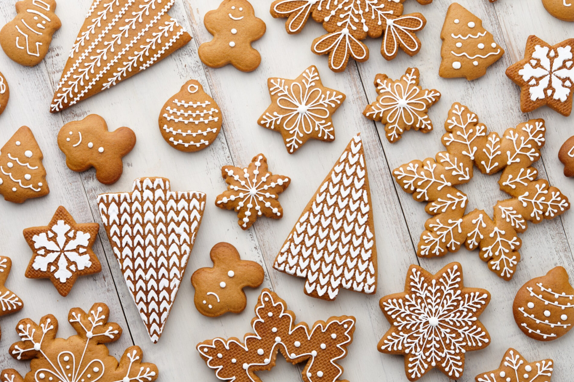 Brown Christmas biscuits with white sugar decoration