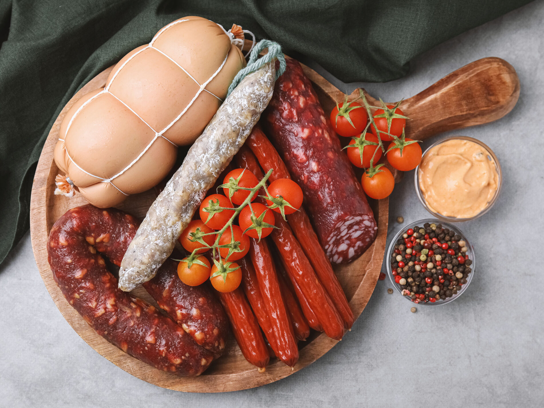 Different kinds of sausages on a wooden cutting board