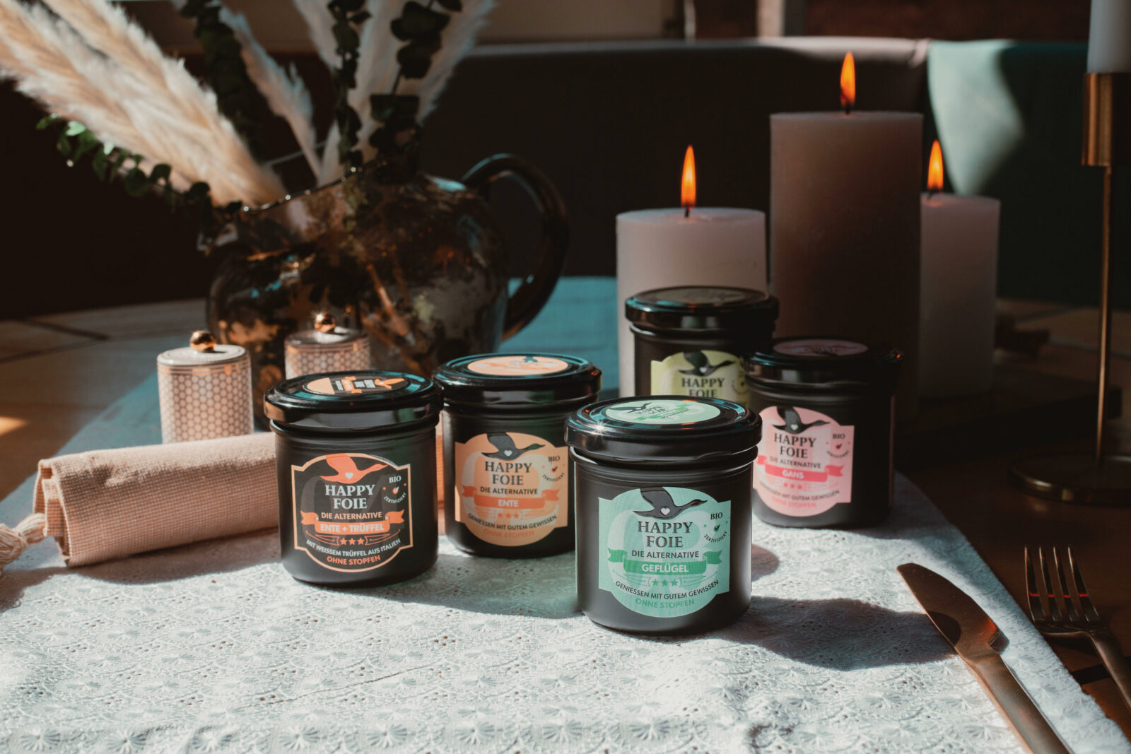 Foie Gras products on a table with candles in background